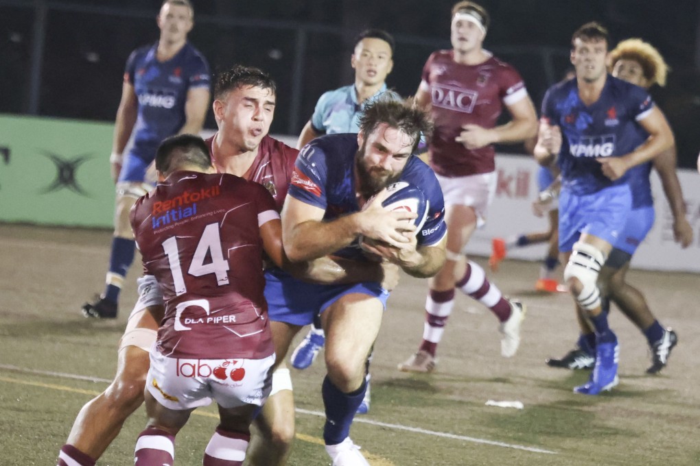 HK Scottish full back Sean Taylor is tackled by Kowloon’s Fong Kit-fung during last Saturday’s premiership clash at King’s Park. Photo: Jonathan Wong