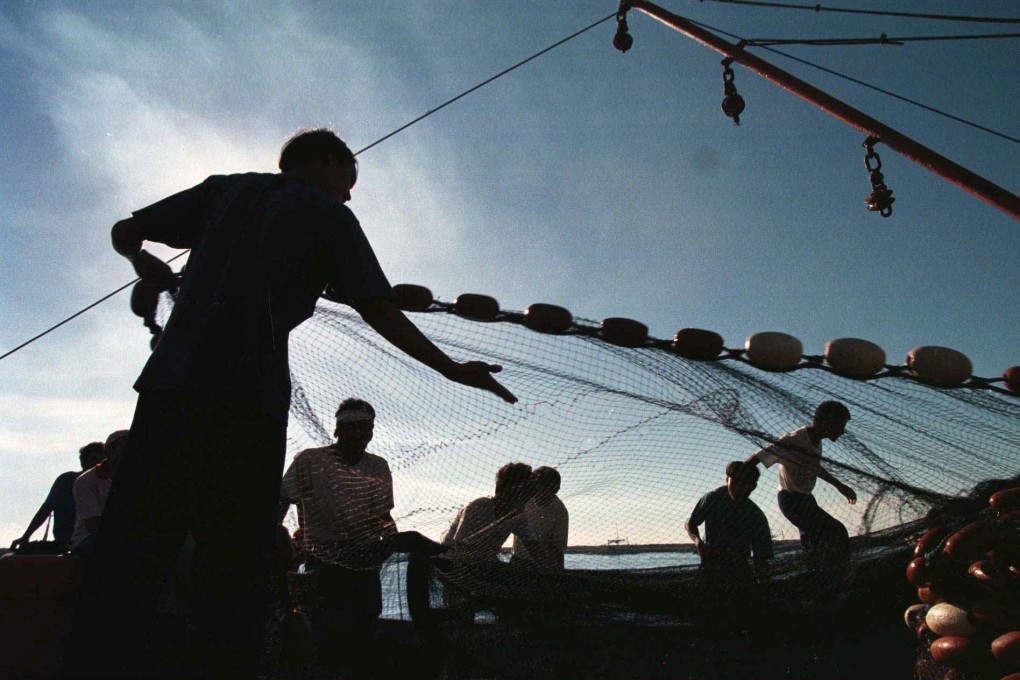 Filipino fishermen -- on frontline of Beijing’s battle in disputed South China Sea -- prepare their nets for another day’s work after unloading their tuna catch. Photo: AP/File
