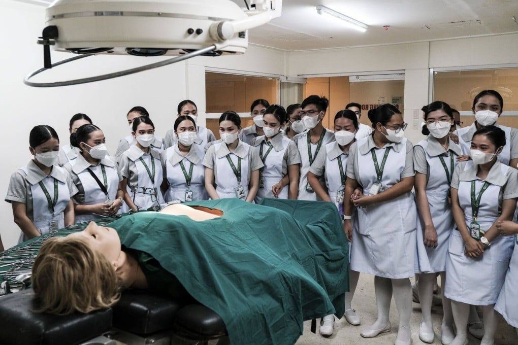 Student nurses with a dummy patient at a Philippine college. Photo: Bloomberg