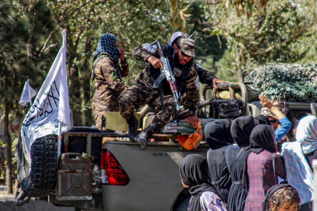 Taliban security forces arrive as Afghan women march during a demonstration after a suicide bomb attack at the Dasht-e-Barchi learning centre in Kabul on October 1. Under Taliban rule, Afghanistan’s future remains uncertain. Photo: AFP