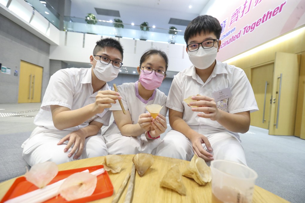 (L-R)Tang Kai-yeung, Kwan Ho-ting and Ho Cheuk with their roasted kombucha straws and cups made of fruit peels. Photo: Handout