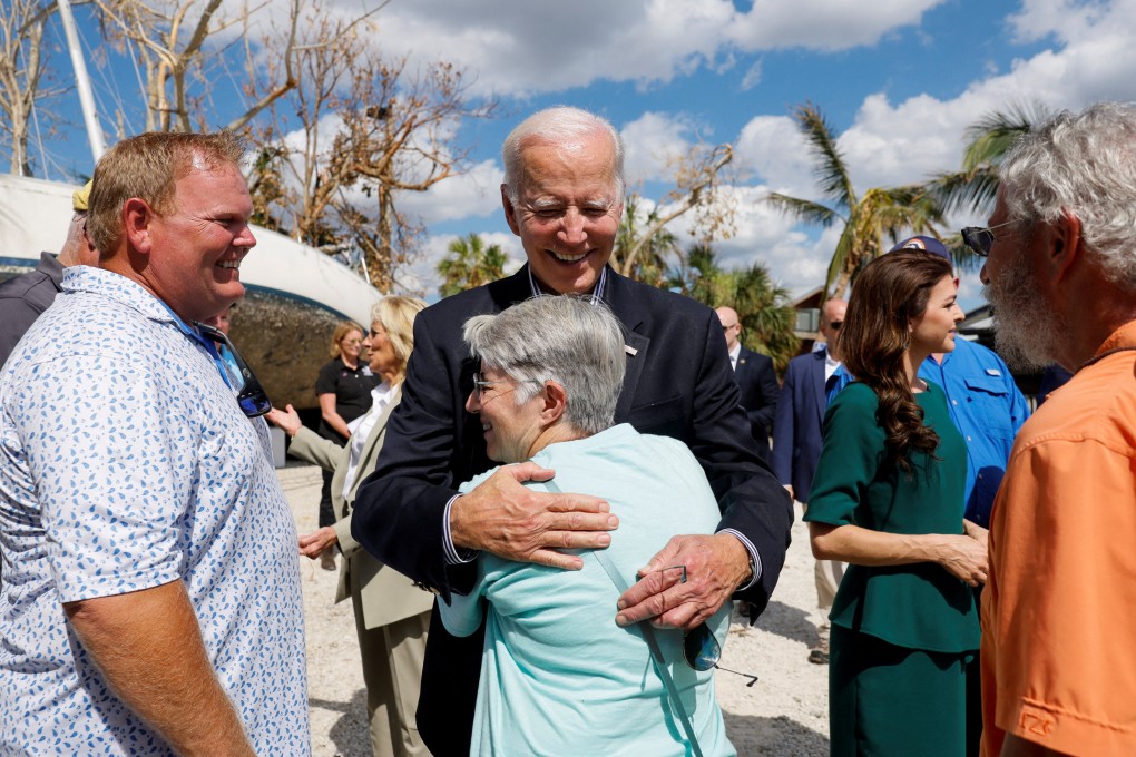 US President Joe Biden hugs a woman as inspects the damage done by Hurricane Ian in Fort Myers Beach, Florida, on Wednesday. Photo: Reuters