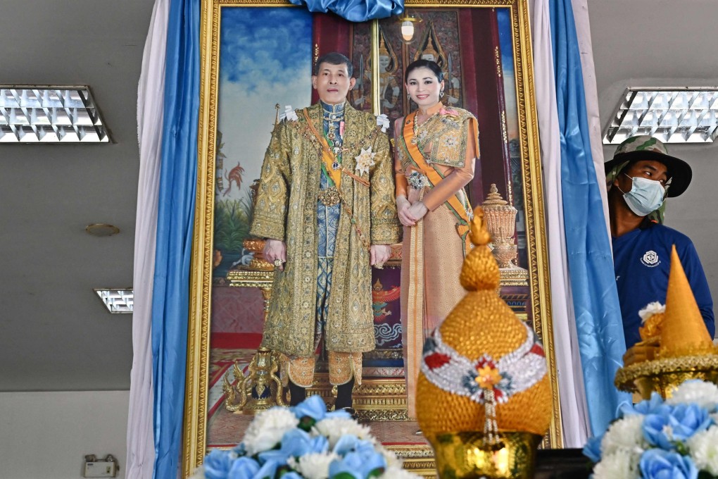 A worker sets up a portrait of Thailand’s King Maha Vajiralongkorn and Queen Suthida ahead of their visit to the hospital where injured survivors were taken after a mass shooting at a nursery. Photo: AFP