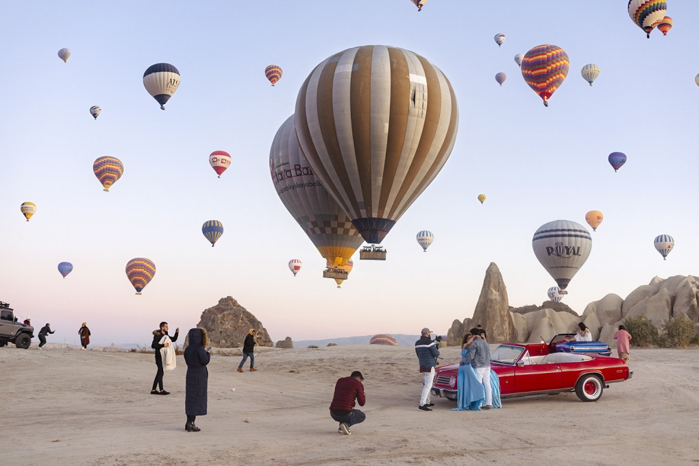 An image from photographer Natacha de Mahieu’s new series “Theatre of Authenticity” of Cappadocia, in Türkiye, where thousands of travellers jostle for space each morning to take selfies and pose on vintage cars. Photo: Natacha de Mahieu