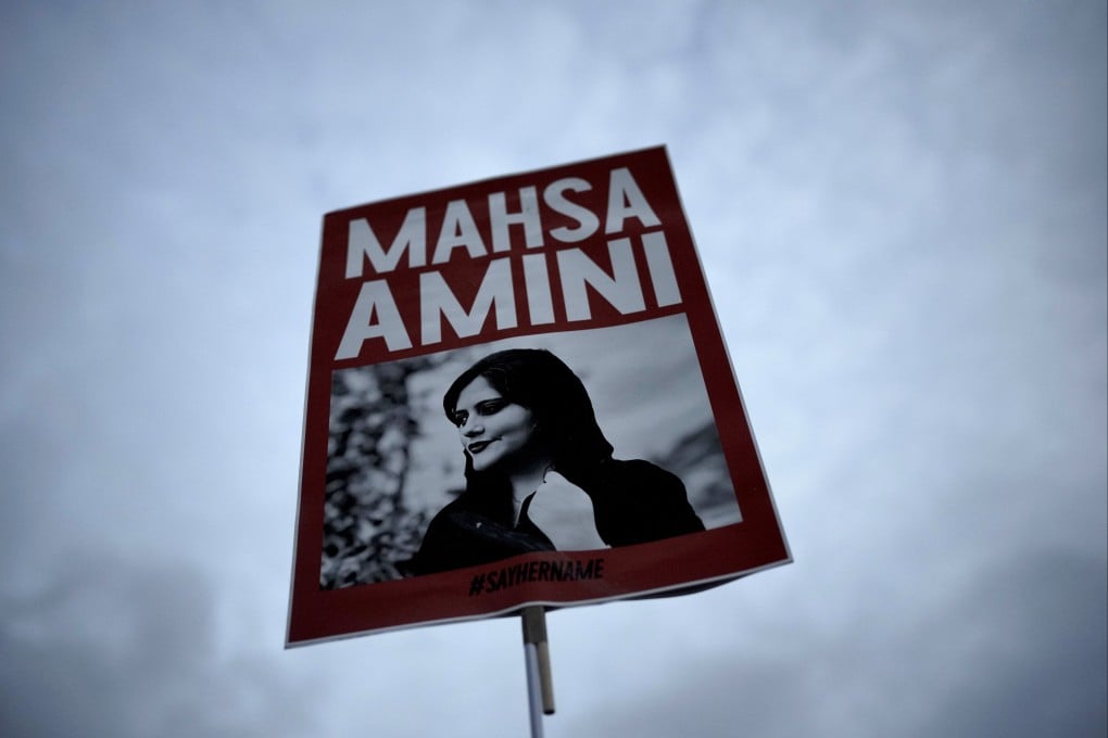 A placard with a picture of Iranian woman Mahsa Amini is held up at a protest in Berlin, Germany in September. Photo: AP