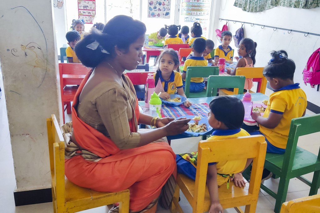 Kids Dream World headmistress, Pramila Naomi (left) feeding a student. Photo: Dimuthu Attanayake