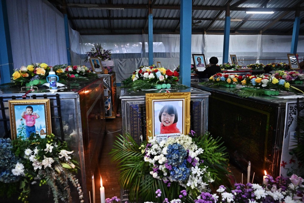 Coffins of victims of Thailand’s mass shooting at a nursery school lay decorated with flowers. Photo: AFP