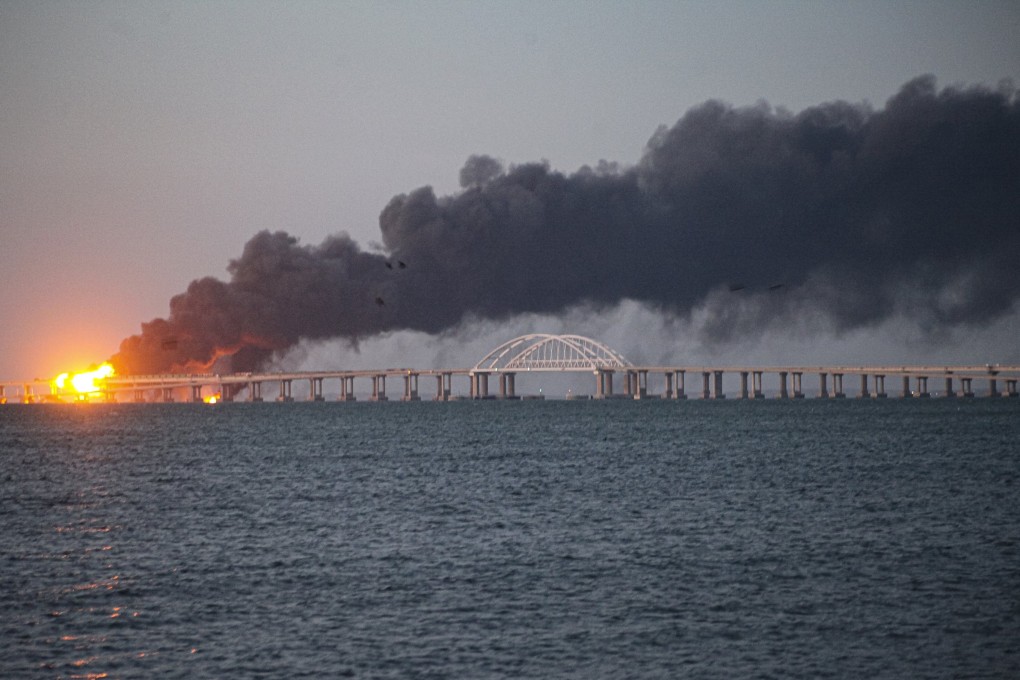 Flames and smoke rise from the Crimean Bridge connecting Russia and the Crimean peninsula over the Kerch Strait near Kerch, Crimea on Saturday. The bridge is a key supply artery for Moscow’s faltering war effort in southern Ukraine. Photo: AP