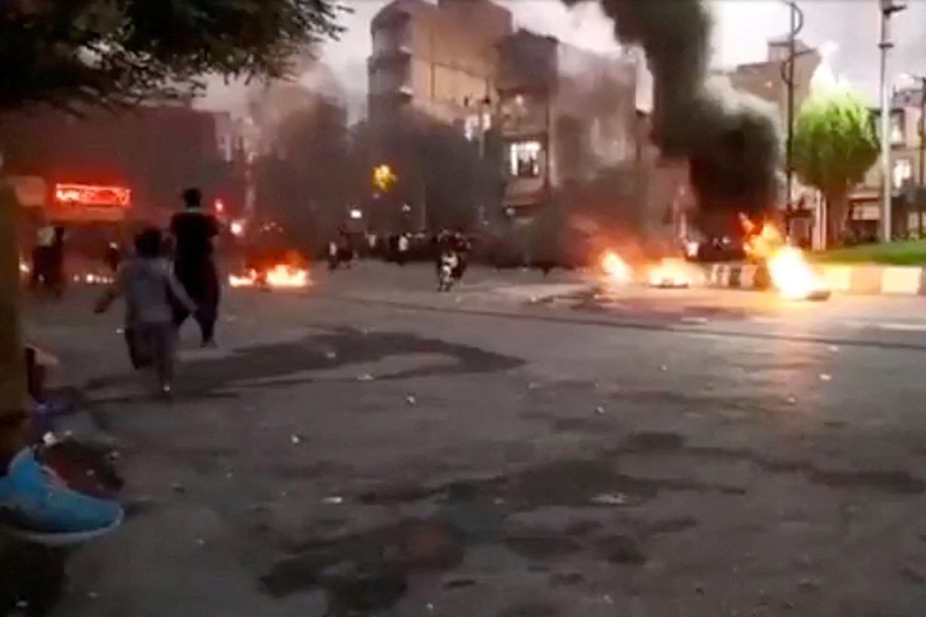A person rides a motorcycle amid a fire during a protest over the death of Mahsa Amini, in Javanrud, Iran in a screengrab from a social media video released on Saturday and obtained by Reuters. Photo: Reuters