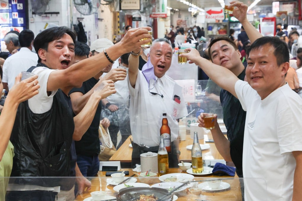 Robby Cheung (centre), owner of Tung Po Kitchen, toasts with customers at the restaurant in North Point. Cheung intends to reopen in November in Wan Chai. Photo: Edmond So