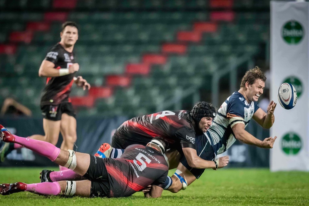 HKFC’s Josh Hrstic offloads under pressure from Valley’s James Cunningham who will start for Hong Kong in Dubai. Photo: Ike Li