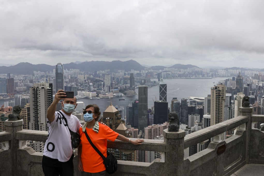 People take a photograph at a relatively empty viewing spot on The Peak, one of Hong Kong’s tourist attractions, on June 21. Photo: K. Y. Cheng
