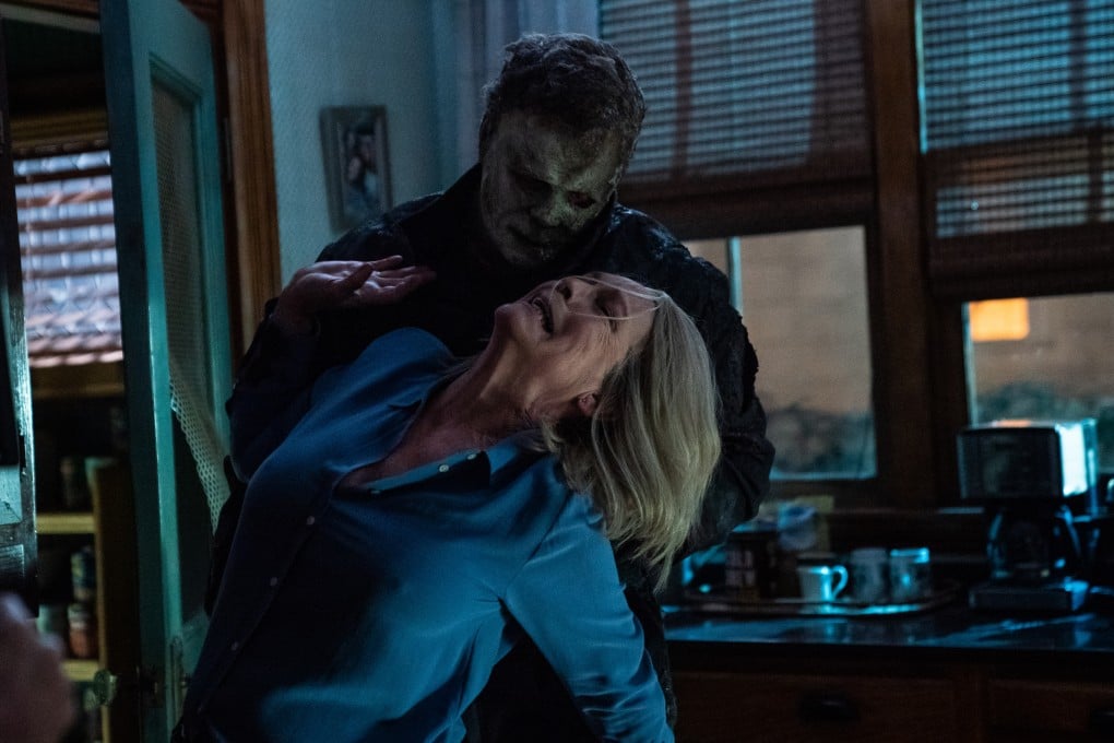 Jamie Lee Curtis (front) as Laurie Strode, and James Jude Courtney as The Shape, in a still from Halloween Ends.