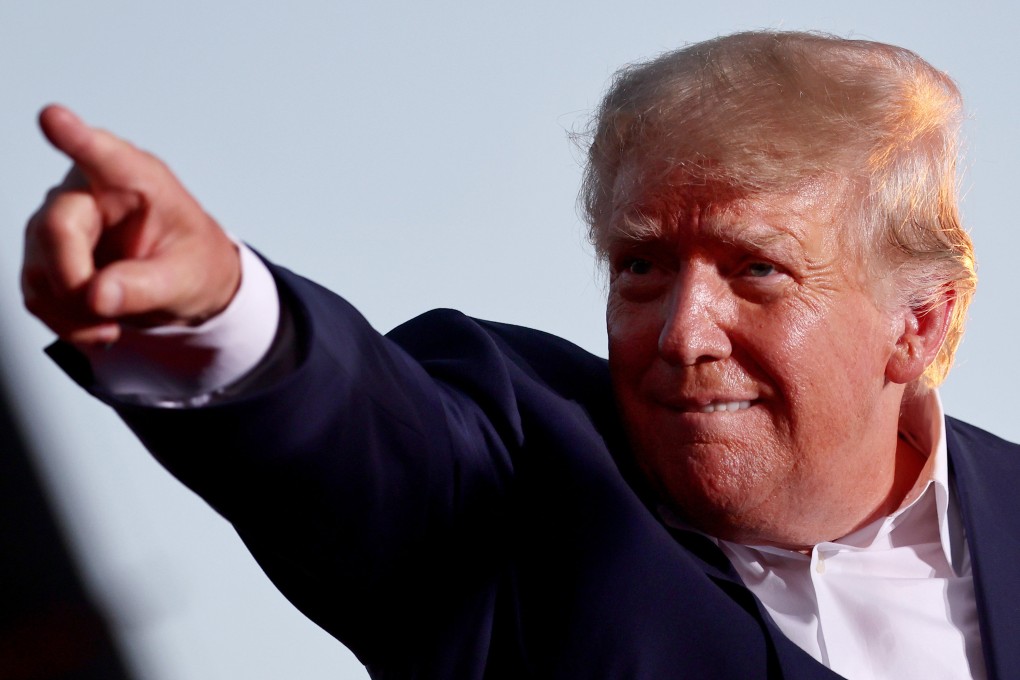 Former US president Donald Trump gestures to the crowd at a campaign rally in Mesa, Arizona, on Sunday. Photo: TNS