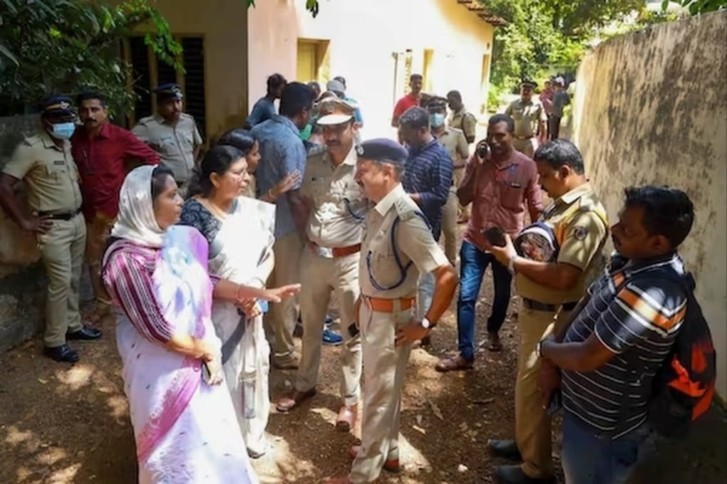 Police and locals at the site where the two women were allegedly murdered and buried at Elanthoor in Kerala. Photo: PTI
