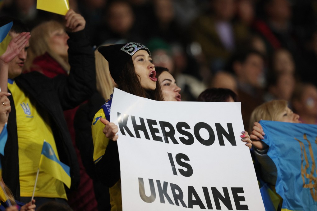 A Dynamo Kyiv football fan with a banner. Photo: Reuters