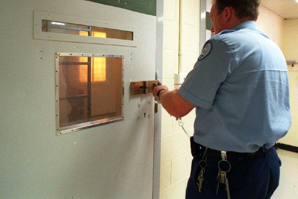 A prison officer in Australia locks up a cell. A UN team is due in the country to put pressure on it to do more to improve conditions for detainees and prevent human rights abuses. File photo: AFP
