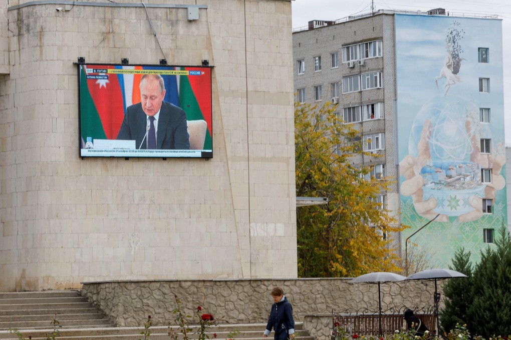 Russia’s President Vladimir Putin is seen on a screen during the broadcast of a Russian state TV news report in the city of Enerhodar in the Zaporizhzhia region. Photo: Reuters