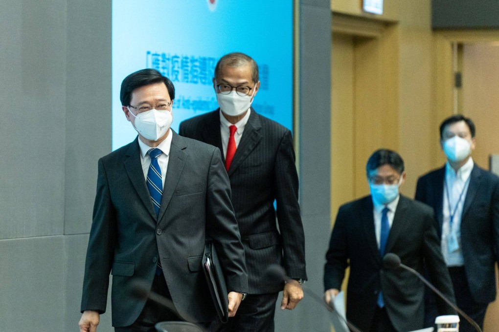 Hong Kong Chief Executive John Lee and health secretary Lo Chung-mau arrive at a news conference in Hong Kong on September 23 to announce the scrapping of hotel quarantine, the most substantial move in the city’s push to end its isolation and salvage its status as a global financial centre. Photo: Bloomberg
