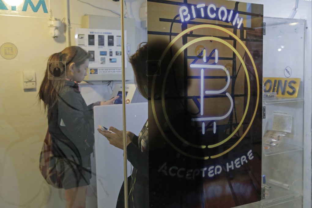 People use a Bitcoin ATM in Hong Kong on December 8, 2017. Photo: AP