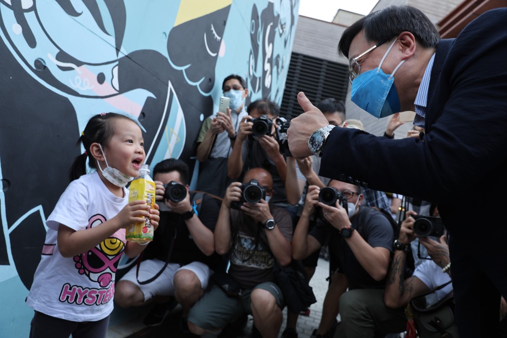 John Lee meets a child during his chief executive campaign in West Kowloon Cultural District on May 4. Photo: Yik Yeung-man