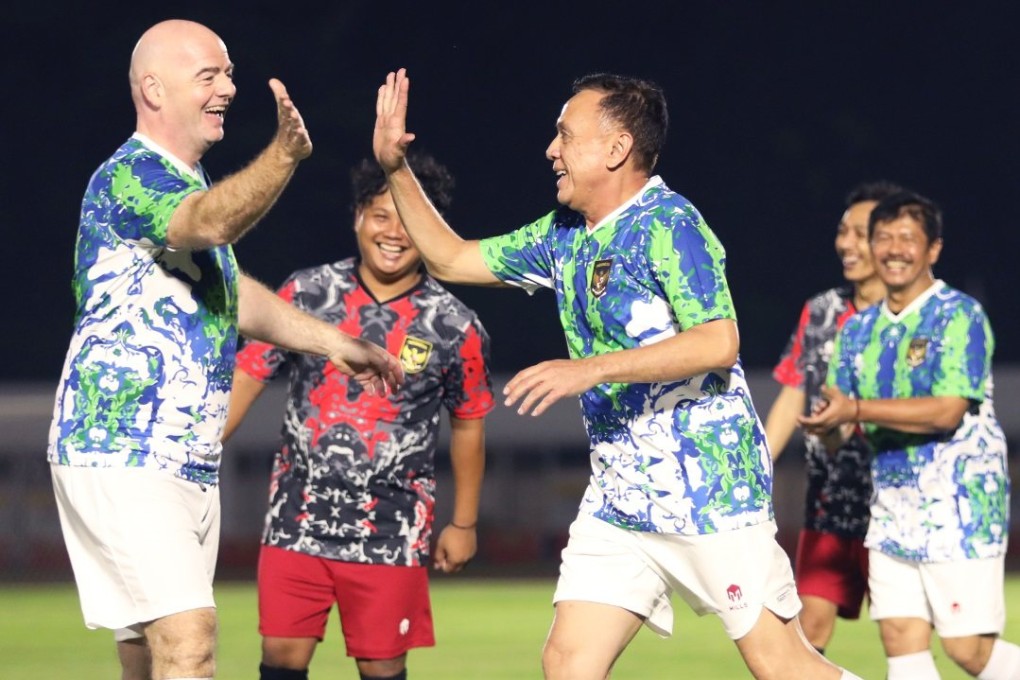 Images of Fifa chief Gianni Infantino high-fiving Indonesian football officials have sparked online fury. Photo: PSSI