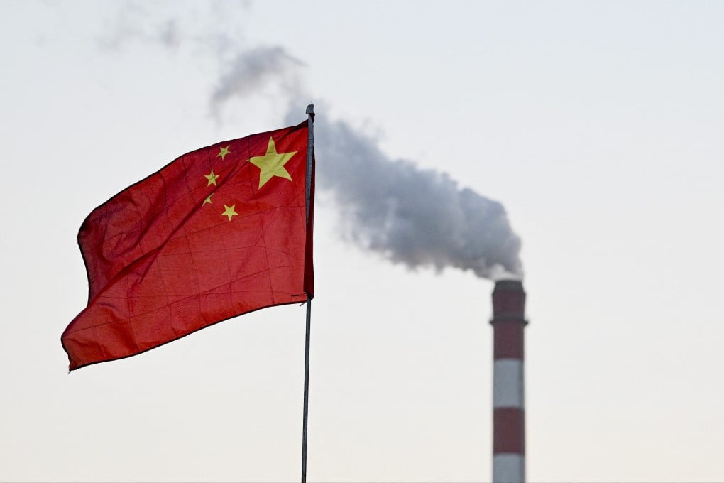 China’s national flag flutters in front of a coal-powered power station in Datong, in China’s northern Shanxi province on November 3, 2021. Photo: AFP