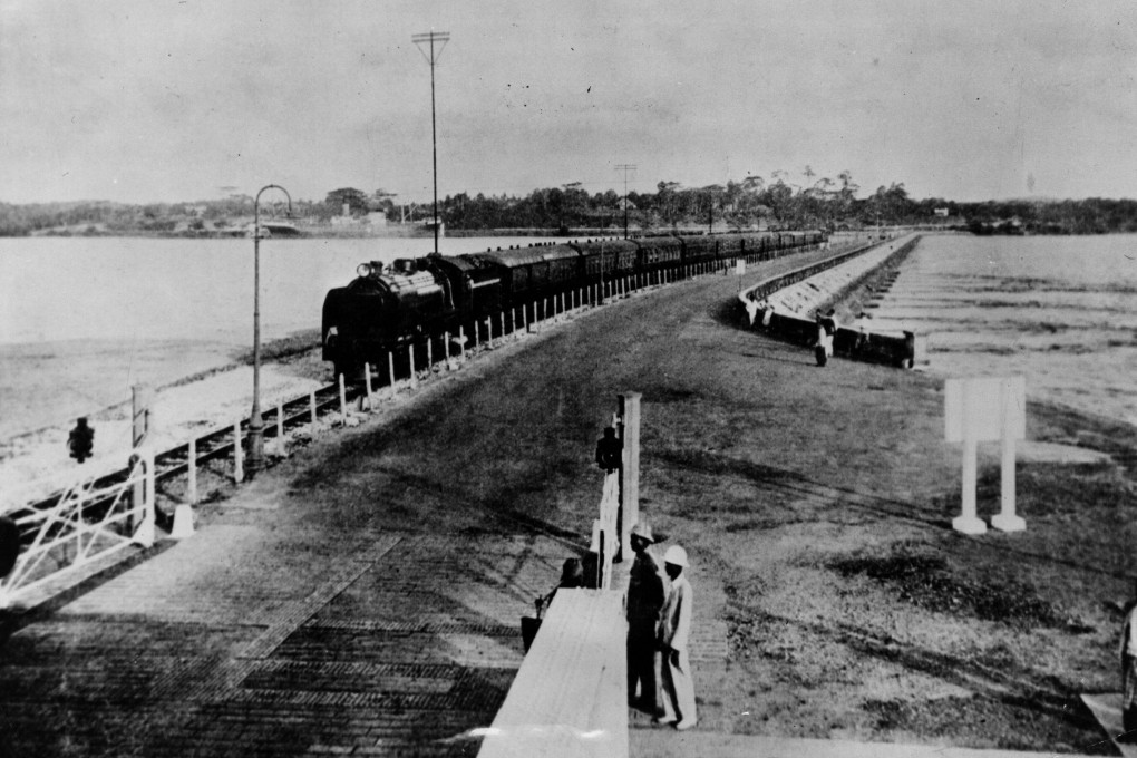 A train crossing the causeway connecting Singapore to the Malay mainland, in 1942. British forces blew up a section of the causeway to, briefly, delay Japanese troops’ advance. Photo: Getty Images