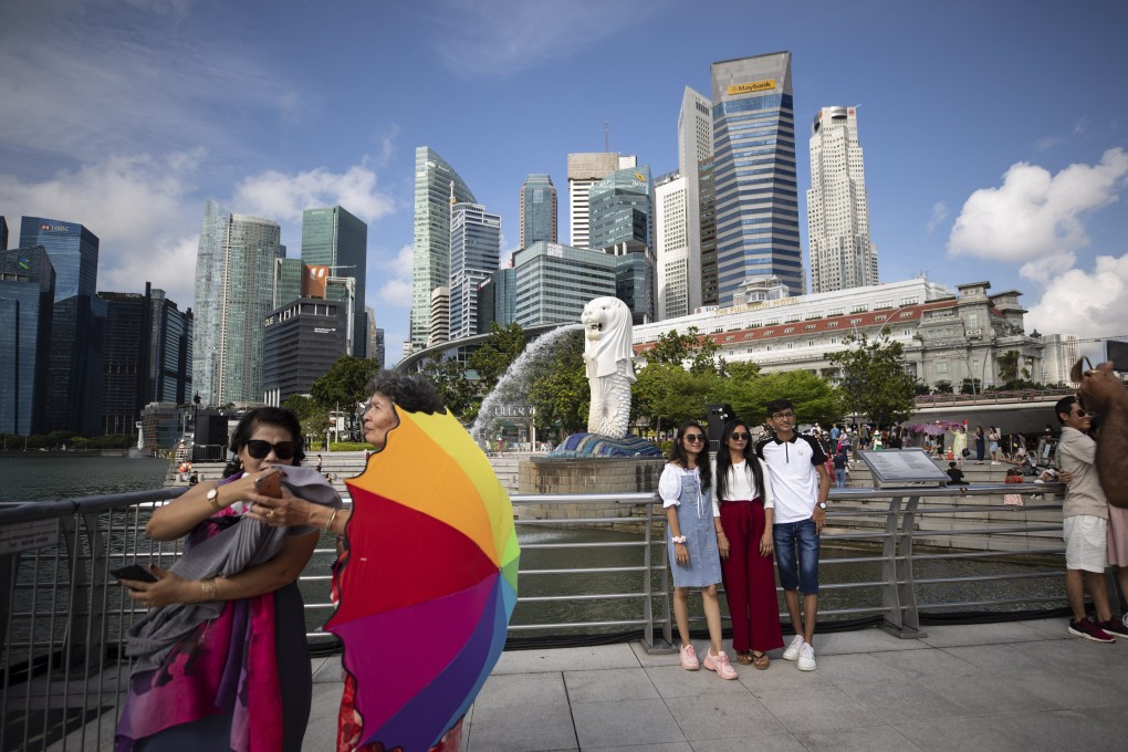 People pose for photos in Singapore in August.  There is concern that some people are now being too complacent about Covid-19. Photo: EPA-EFE