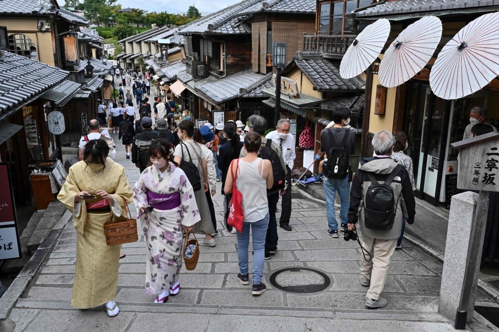 Visitors walk along a lane filled with tourist shops and restaurants leading to the Kiyomizu-dera temple in Kyoto, Japan, on October 13. Photo: AFP