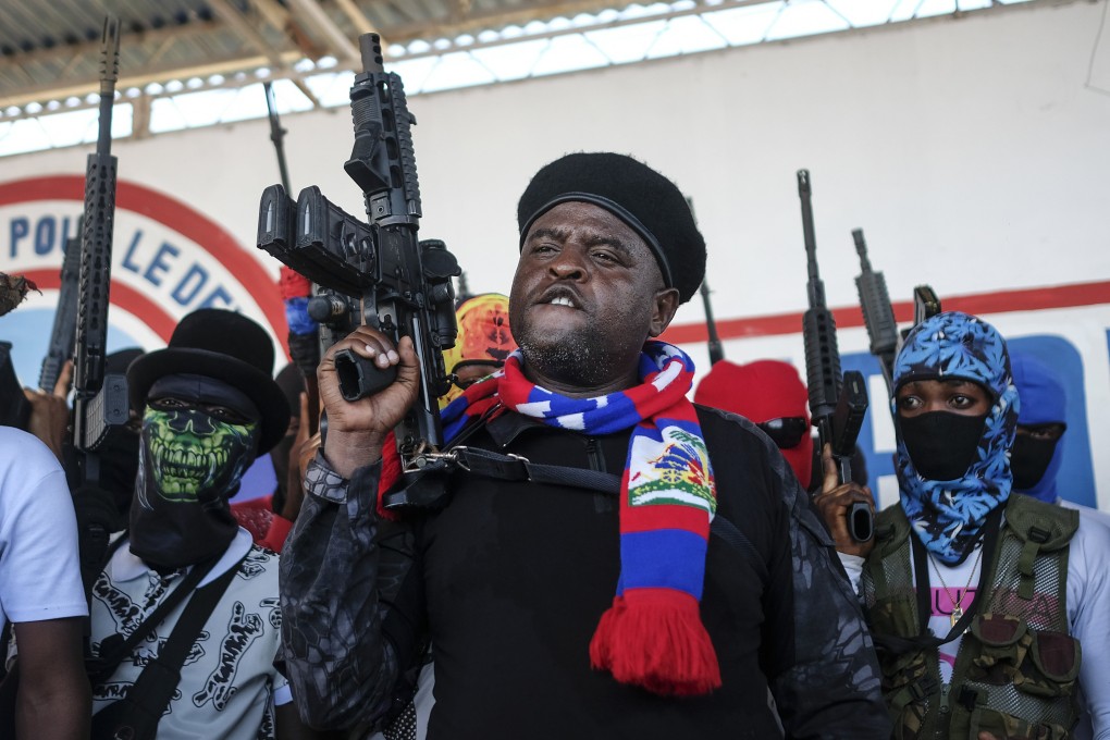 Gang leader Jimmy Cherizier, better known as Barbecue, shouts slogans with his gang members after giving a speech in Port-au-Prince, Haiti in October 2021. Photo: AP