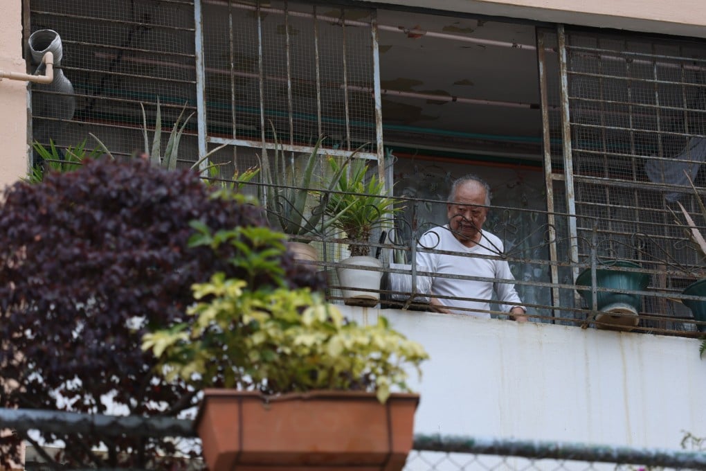 A man looks out from his balcony at Kwun Tong Garden Estate II in Ngau Tau Kok, which will be redeveloped in two phases, on April 11. Photo: Nora Tam