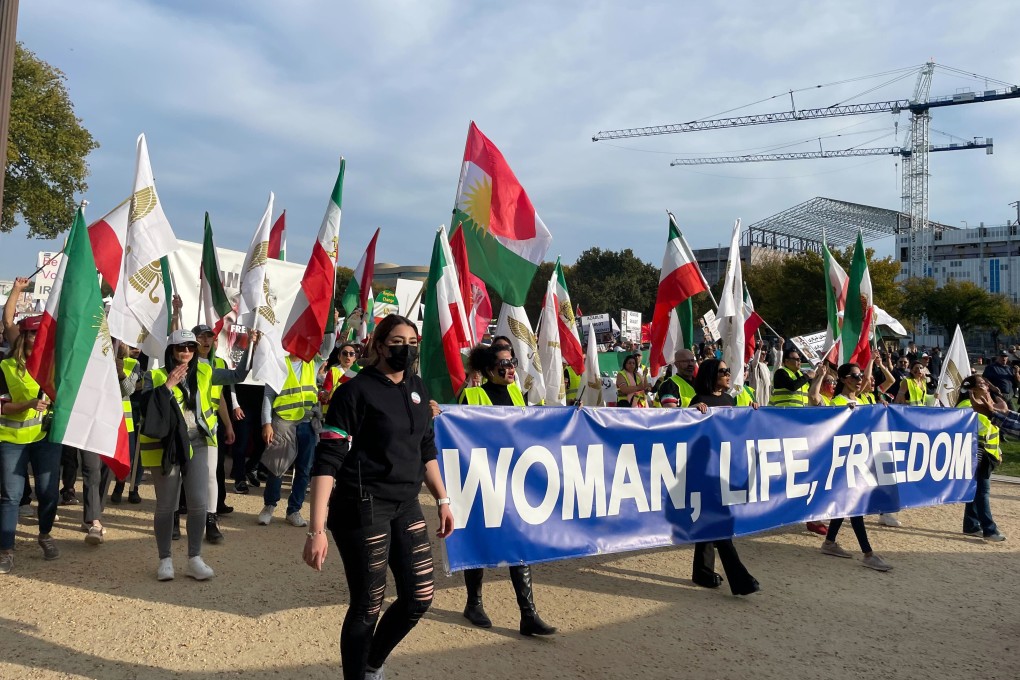 People carry a sign that reads “Woman, Life, Freedom” as hundreds rally on Saturday in Washington in a show of international support for demonstrators facing a violent government crackdown in Iran. Photo: AP
