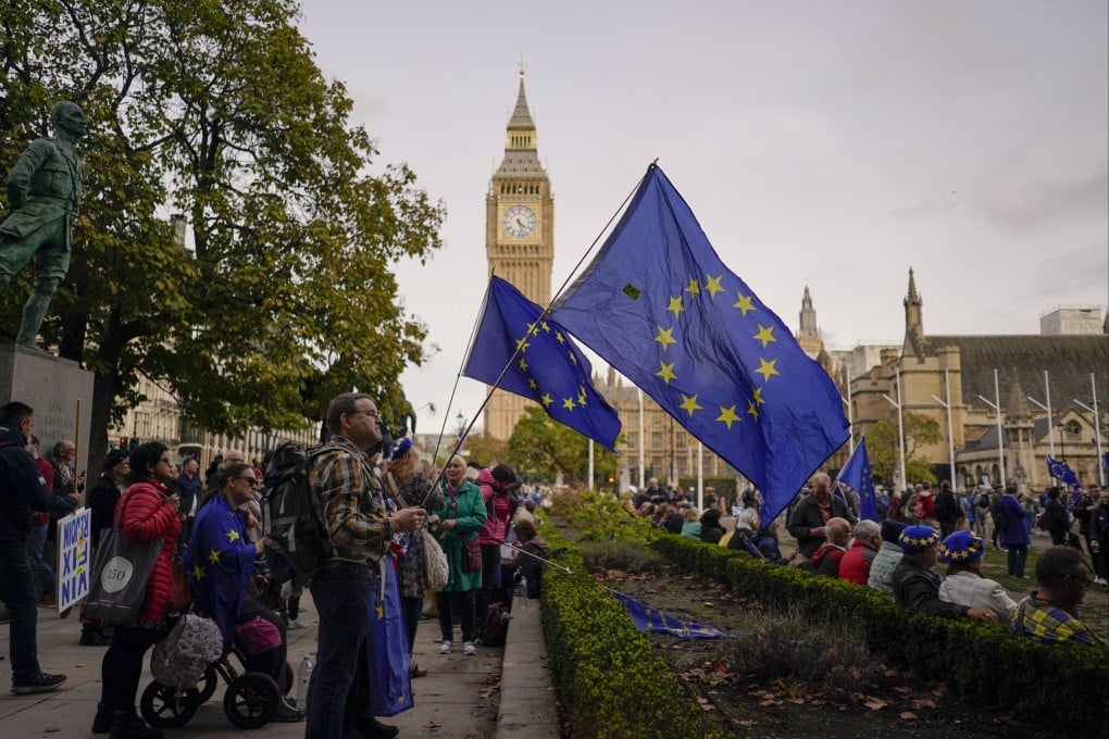 People hold European Union flags as they stand in Parliament Square at the end of a march in support of the EU, in London, UK on Saturday. Photo: AP