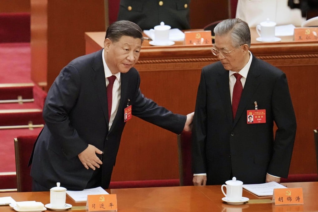 Chinese President Xi Jinping (L) puts a hand on his predecessor Hu Jintao during the opening ceremony of the 20th National Congress of the Chinese Communist Party on October 16, 2022. Photo: Kyodo