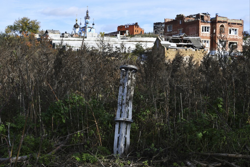 The tail of a missile sticks out in a residential area in the retaken village of Bohorodychne, eastern Ukraine. Photo: AP