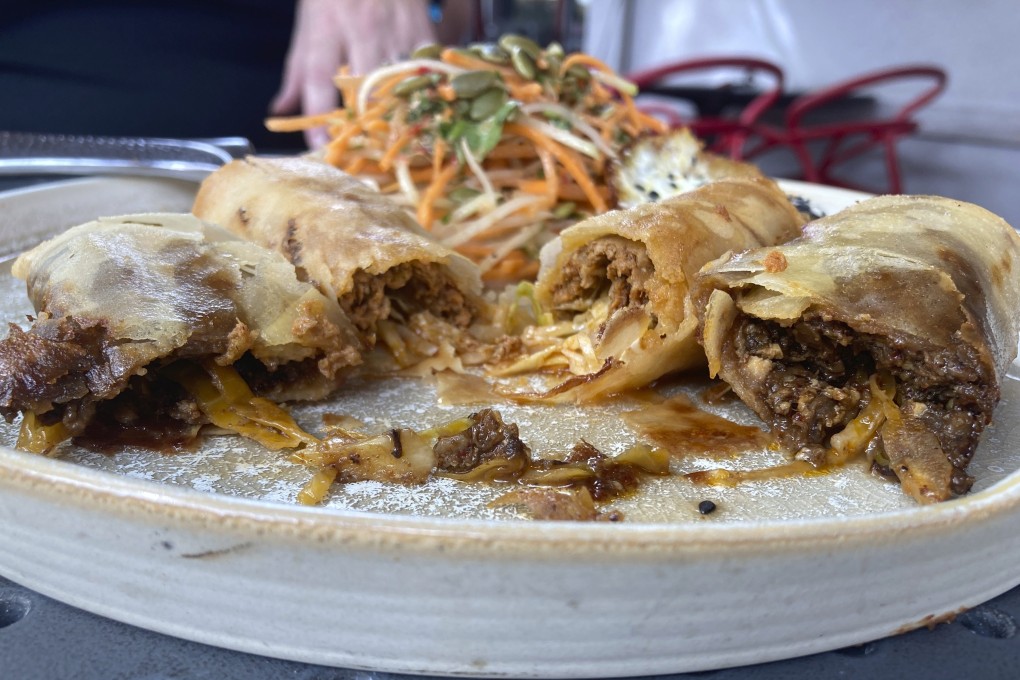 A vegan chorizo egg roll and a meat chorizo egg roll topped with a fried egg and a papaya and carrot slaw at Boca restaurant in Tucson, Arizona, served as part of the Tuscon Chinese Chorizo Festival. Photo: AP/Terry Tang