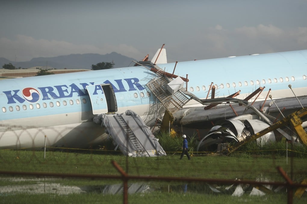 A guard inspects a Korean Air plane that overshot the runway in Cebu City, central Philippines, on Monday. Photo: AP