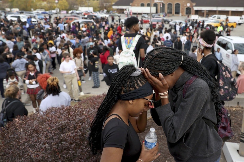 Students stand in a parking lot near the Central Visual & Performing Arts High School after a shooting in St Louis on Monday. Photo: St Louis Post-Dispatch via AP