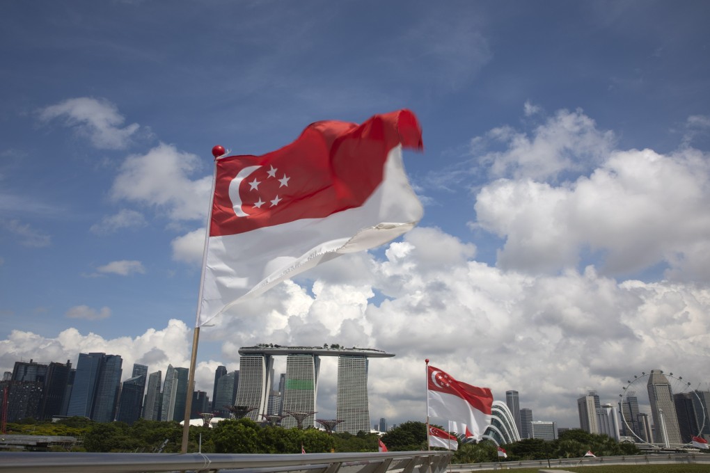 Singapore national flags flutter over a view of the city skyline earlier this year. Photo: EPA-EFE