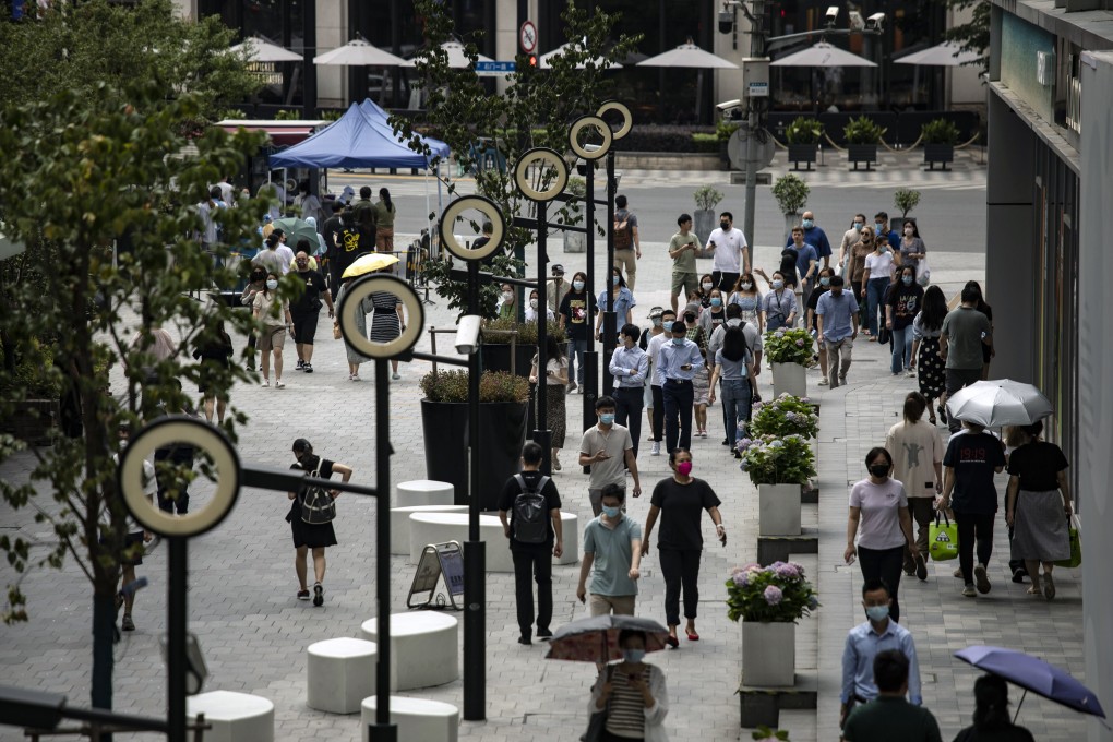 Pedestrians walked along a road in Shanghai on June 29, 2022 after the city’s authorities declared victory in their defence of the financial hub against Covid-19. Photo: Bloomberg.
