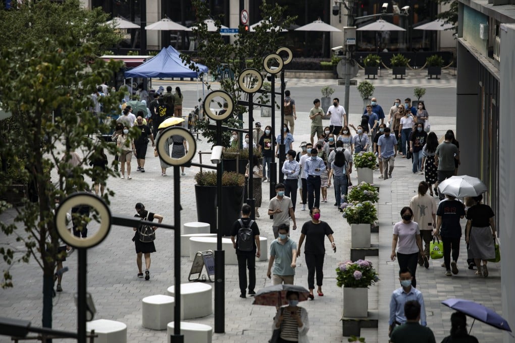 Pedestrians walked along a road in Shanghai on June 29, 2022 after the city’s authorities declared victory in their defence of the financial hub against Covid-19. Photo: Bloomberg.