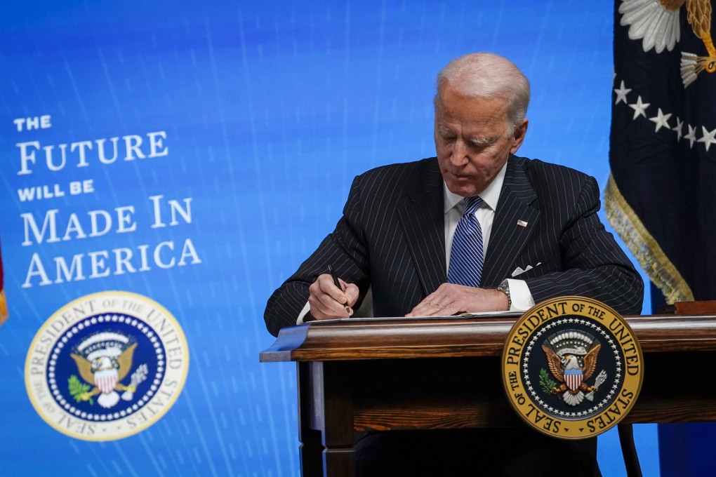 US President Joe Biden signs an executive order regarding American manufacturing on January 25, 2021. Photo: Getty Images/TNS