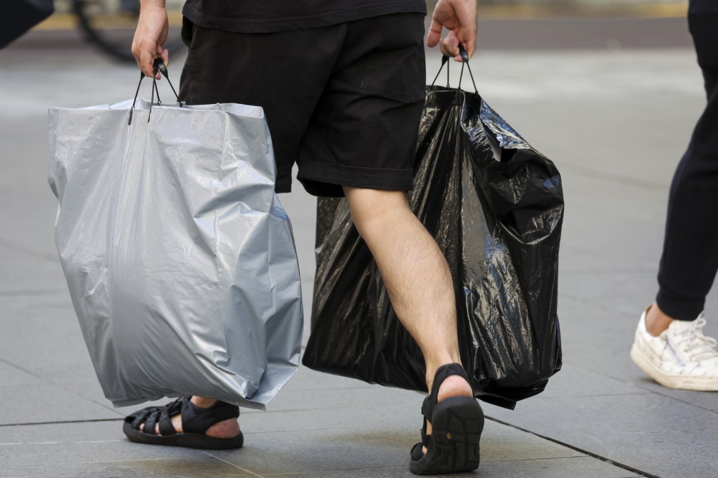 People using plastic bags in Tsim Sha Tsui on July 27. The levy on plastic bags in Hong Kong will soon increase to HK$1. Photo: Edmond So