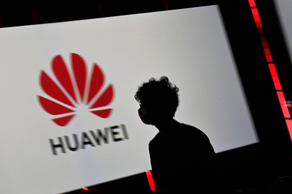 A visitor walks past the Huawei logo on a screen during an electronics trade show in Berlin in September 2020. Photo: AFP