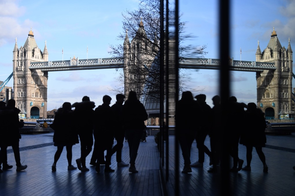 People walk near Tower Bridge in London on February 11. While the UK is a popular destination for Hongkongers wishing to study abroad, the country is now facing a cost-of-living crisis. Photo: EPA-EFE