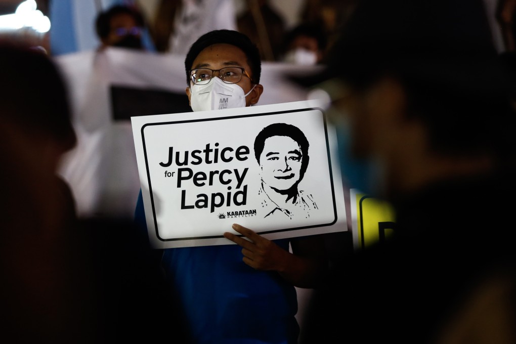 A protester holds a sign with an image of slain broadcast journalist Percy Mabasa, also known as Percy Lapid, during a rally in Quezon City, Metro Manila earlier this month. Photo: EPA-EFE