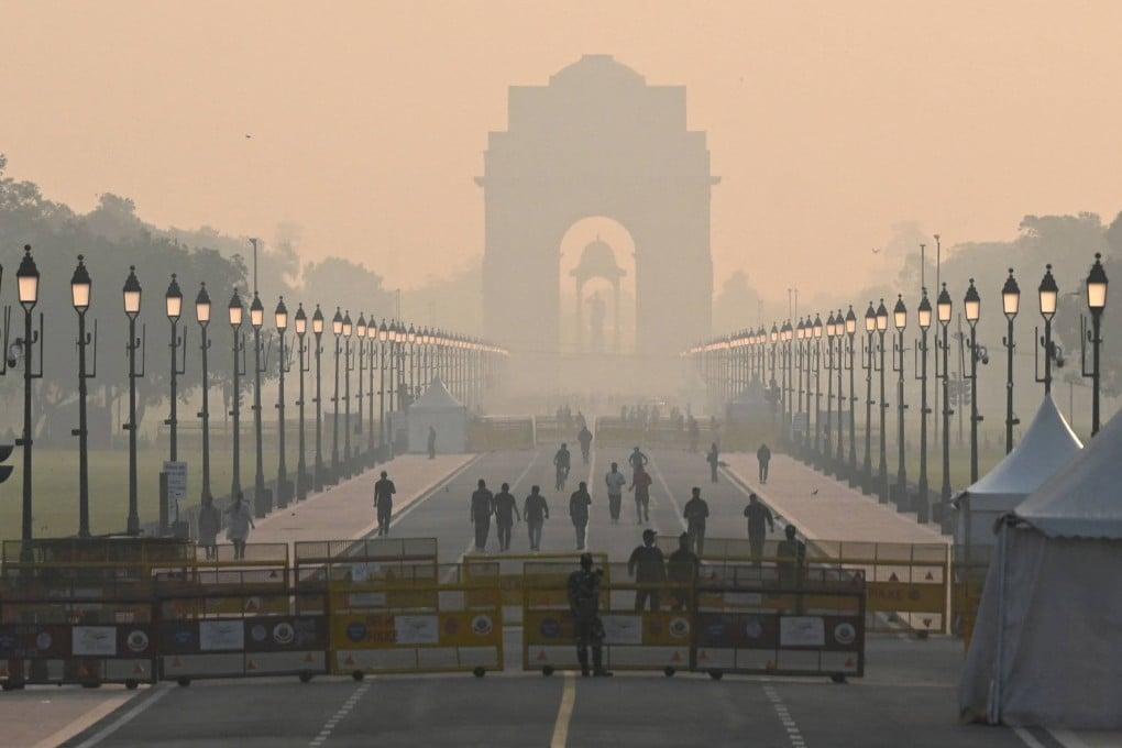 People walk along a road near India Gate amid smoggy conditions in New Delhi on October 25 after Diwali revellers defied a firecracker ban to celebrate the annual Hindu festival. Photo: AFP