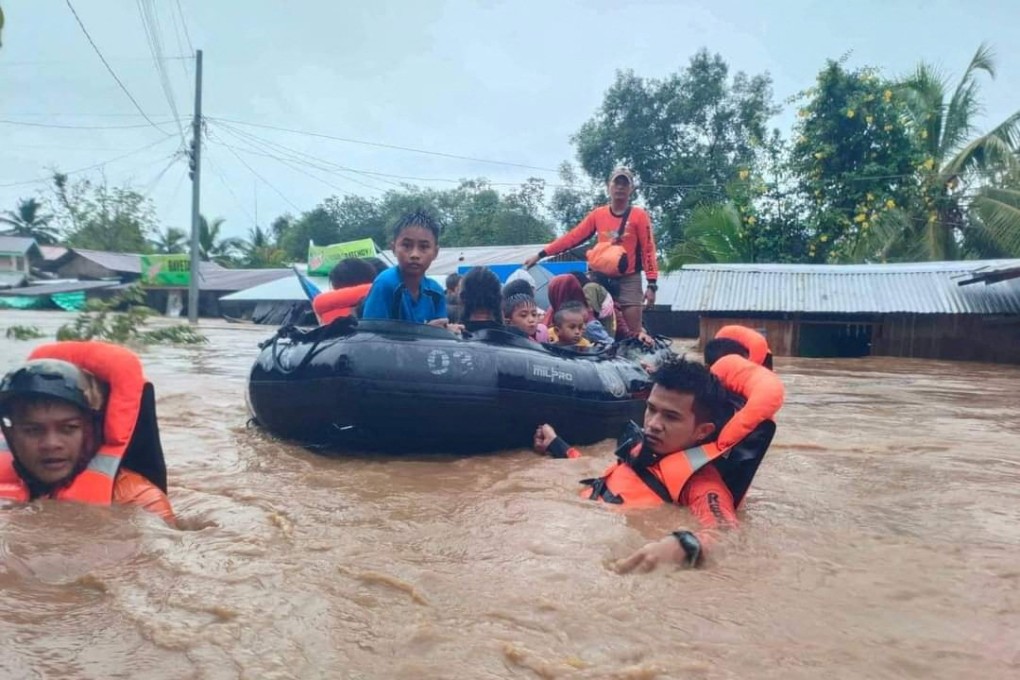 Philippine Coast Guard (PCG) rescuers evacuate residents from their flooded homes due to a tropical storm, locally named Paeng, in Maguindanao province, Philippines. Photo: Philippine Coast Guard/Handout via Reuters