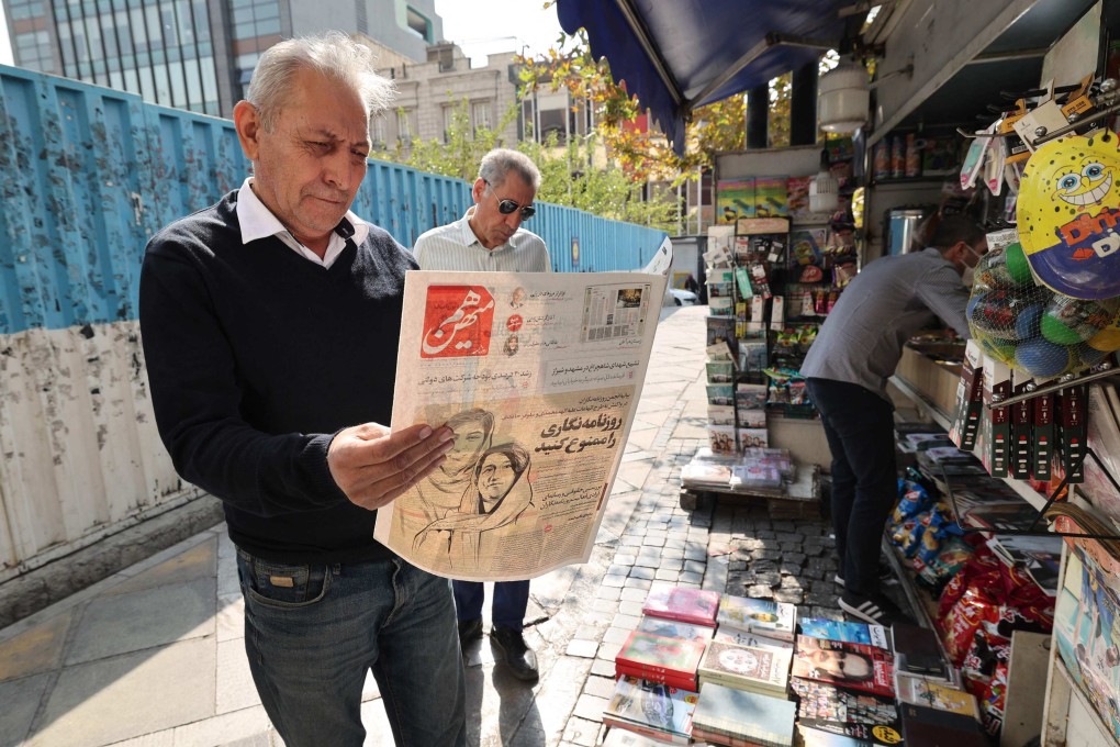 A man in the Iranian capital Tehran reads a copy of the Hammihan newspaper, on October 30, featuring on its cover a headline mentioning the statement by the Tehran journalists’ association, criticising the detention by authorities of two journalists, Niloufar Hamedi and Elaheh Mohammadi (drawing on cover), who according to local media, helped publicise the case of Masha Amini. Photo: AFP